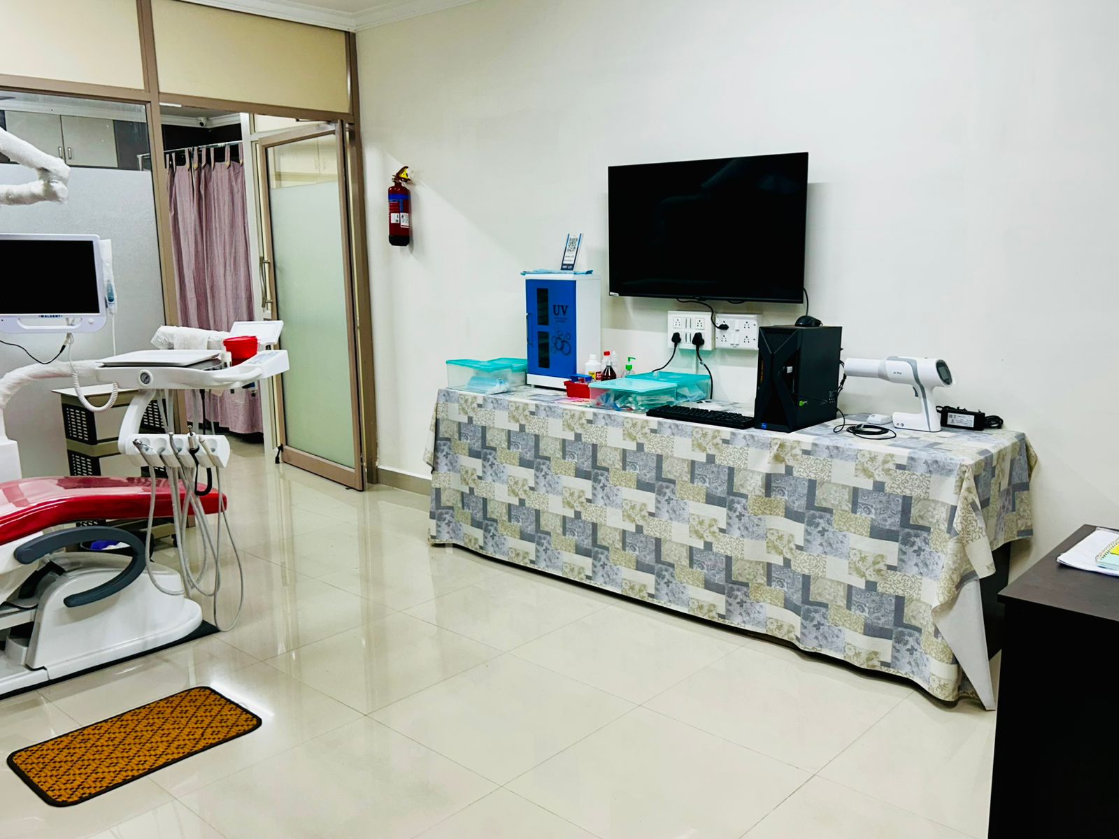 Interior view of a consultation and treatment room with a dental chair